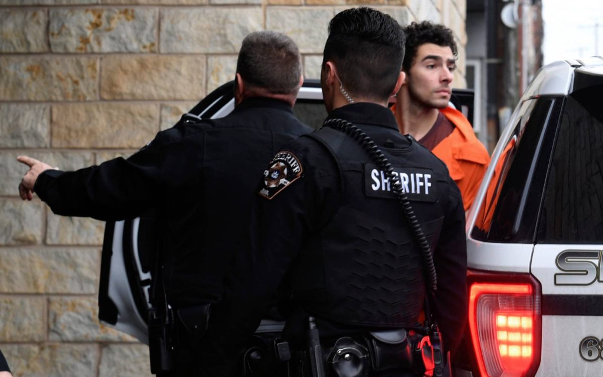 Luigi Nicholas Mangione is escorted into Blair County Courthouse, Tuesday, Dec. 10, 2024, in Hollidaysburg, Pa. (AP Photo/Gary M. Baranec)