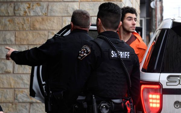 Luigi Nicholas Mangione is escorted into Blair County Courthouse, Tuesday, Dec. 10, 2024, in Hollidaysburg, Pa. (AP Photo/Gary M. Baranec)